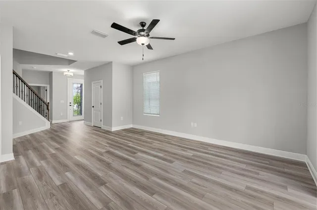 wooden floor in an empty room with a window