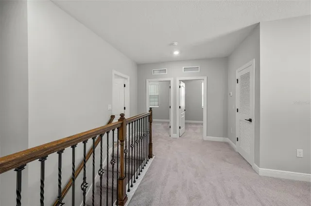 a view of hallway with wooden floor