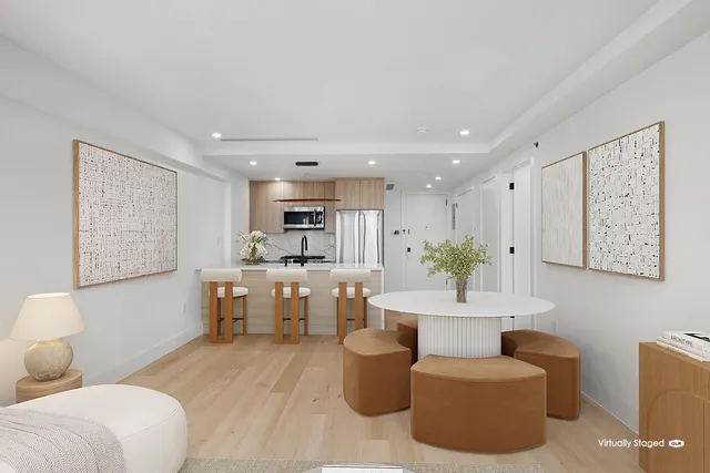 a bedroom with a bed and large windows