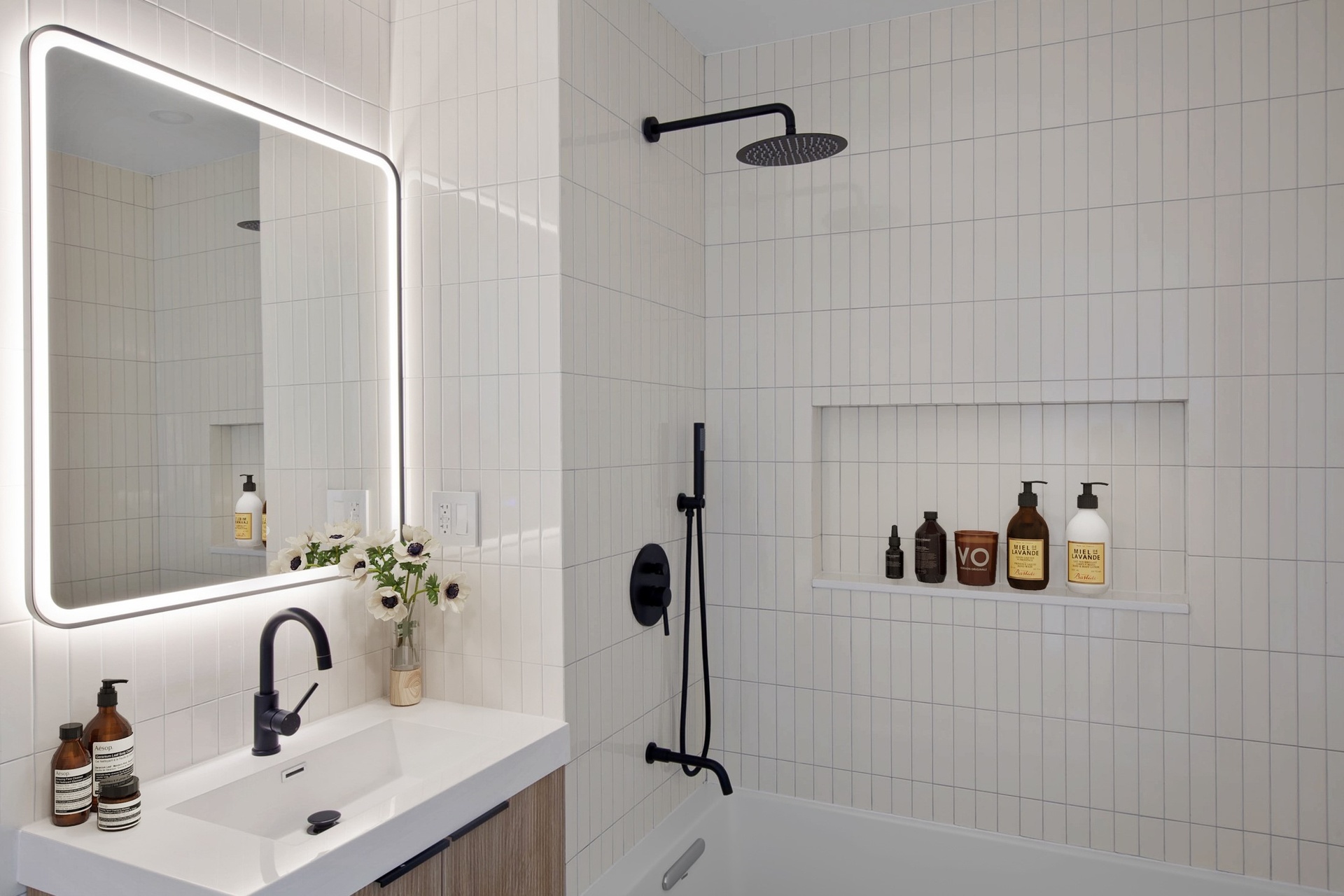 27-23 Crescent Street, Unit 1A Queens, NY 11102 - Photo 6 of 9 a bathroom with a sink and mirror