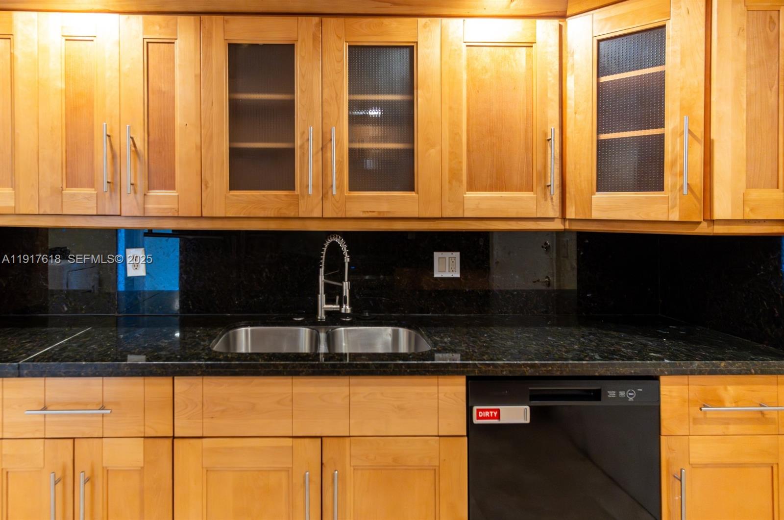 145 Southeast 25th Road, Unit 1003 Miami, FL 33129 - Photo 16 of 43 a kitchen with granite countertop cabinets and a sink
