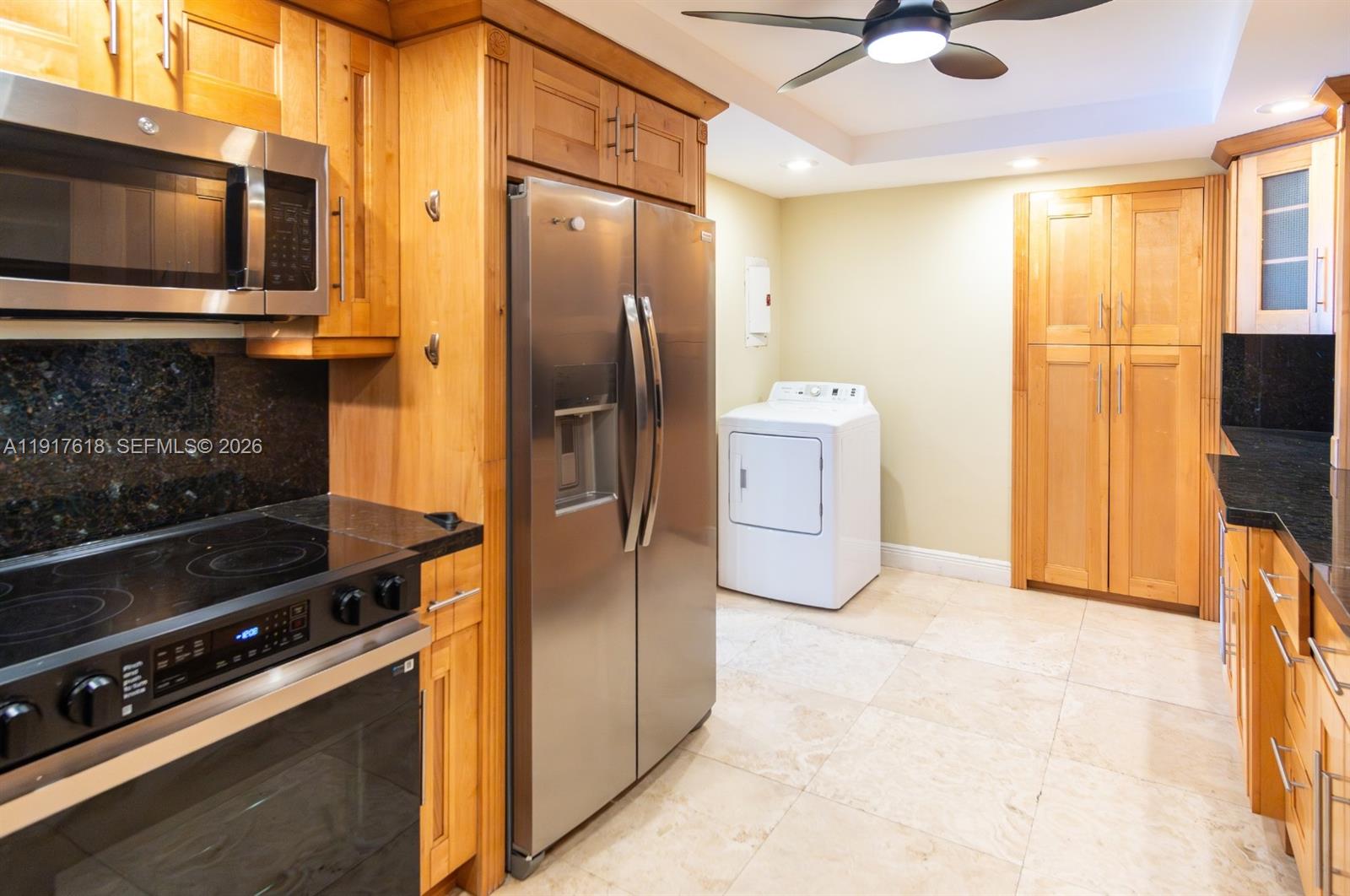 145 Southeast 25th Road, Unit 1003 Miami, FL 33129 - Photo 18 of 43 a kitchen with a refrigerator and a stove