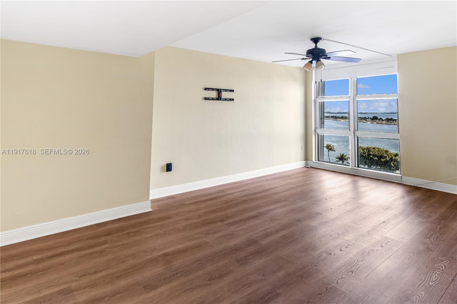 145 Southeast 25th Road, Unit 1003 Miami, FL 33129 - Photo 19 of 43 an empty room with wooden floor and windows