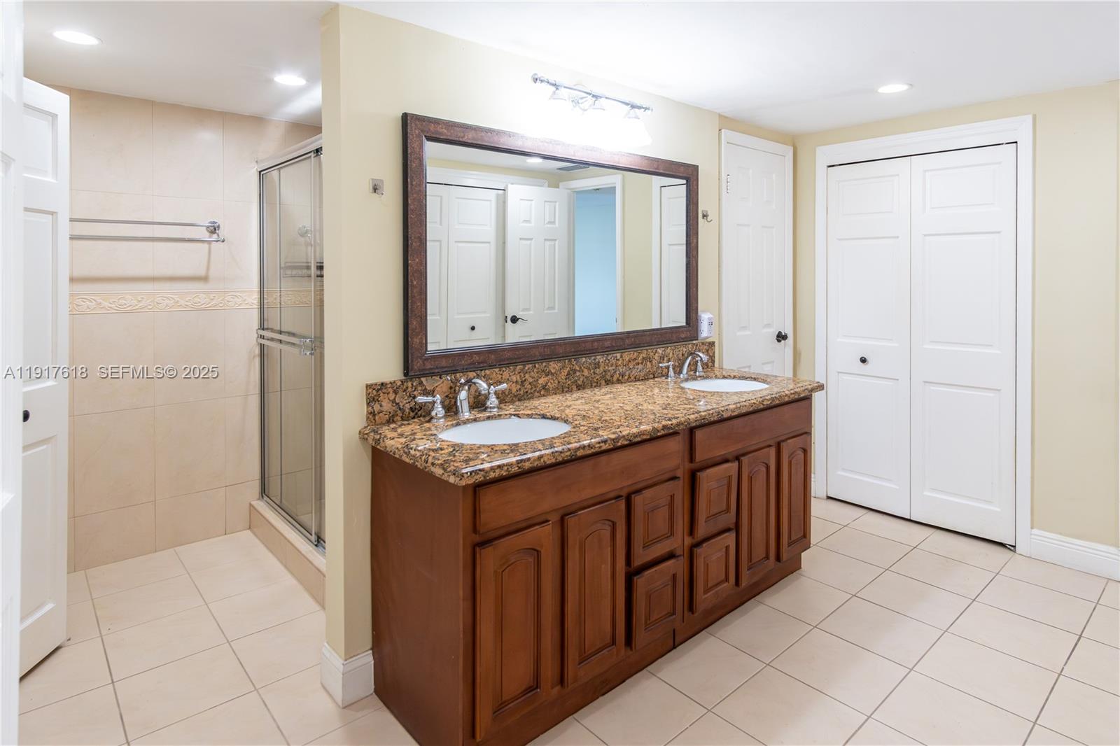 145 Southeast 25th Road, Unit 1003 Miami, FL 33129 - Photo 26 of 43 a bathroom with a granite countertop sink and a mirror