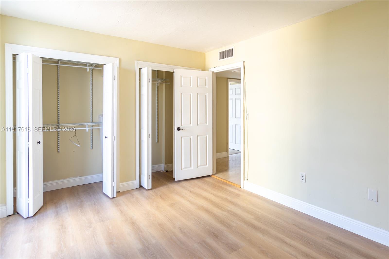 145 Southeast 25th Road, Unit 1003 Miami, FL 33129 - Photo 35 of 43 an empty room with wooden floor and closet