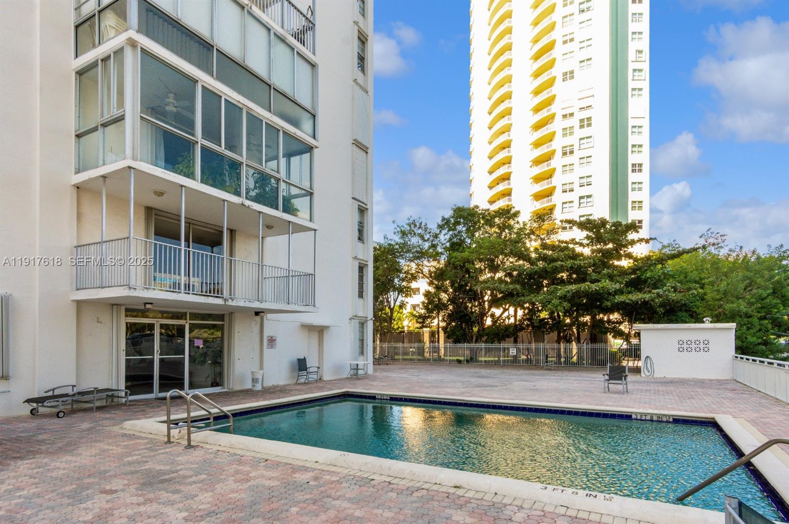 145 Southeast 25th Road, Unit 1003 Miami, FL 33129 - Photo 40 of 43 a view of a swimming pool with a lounge chairs
