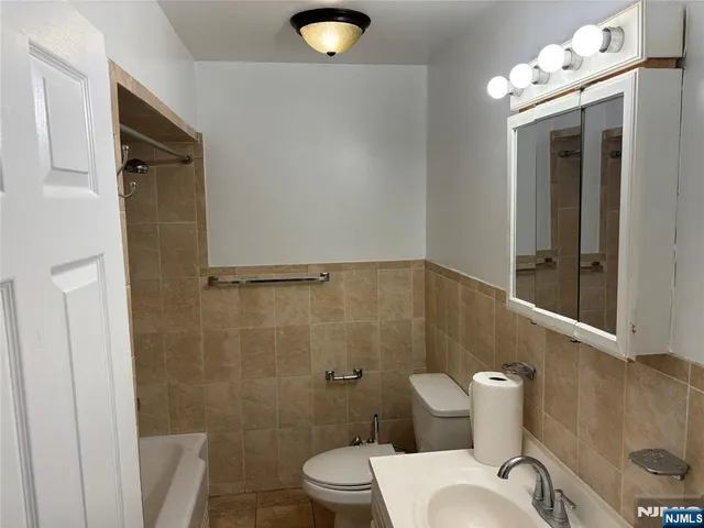 a bathroom with a toilet a sink and shower