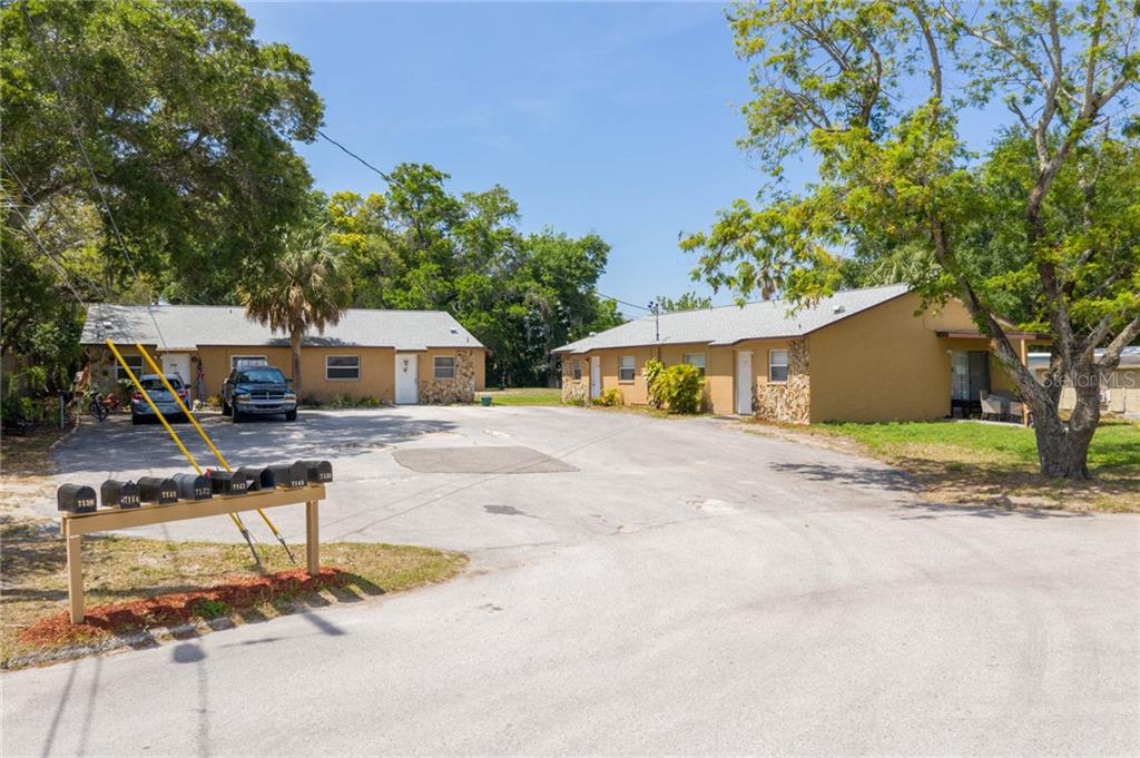 7140 Bellaire Terrace New Port Richey, FL 34653 - Photo 1 of 1 a front view of a house with a yard and trees