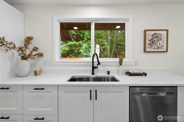a kitchen with a sink and cabinets