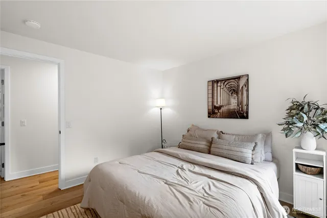 a bedroom with a bed and a potted plant