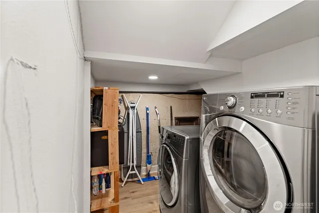 a view of a storage & utility room with dryer and washer