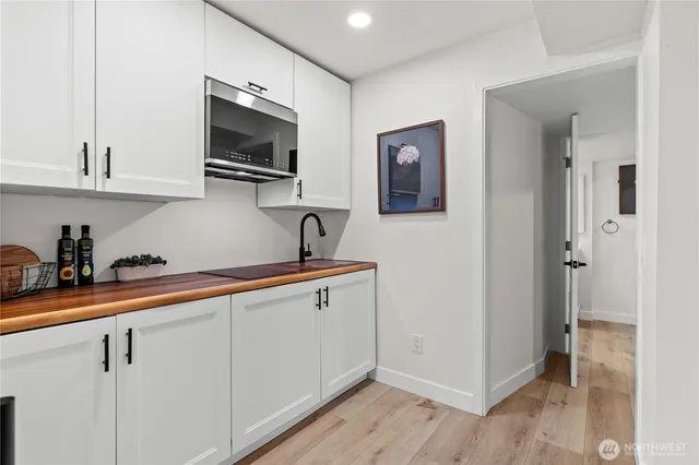 a kitchen with cabinets and a wooden floor