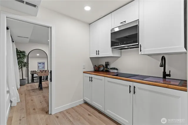 a kitchen with stainless steel appliances a sink microwave and stove