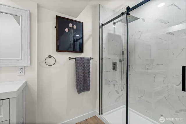 a bathroom with a shower and mirror