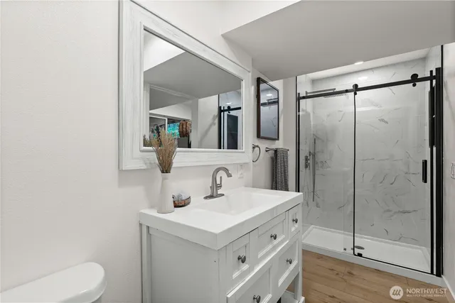 a bathroom with a sink toilet and shower