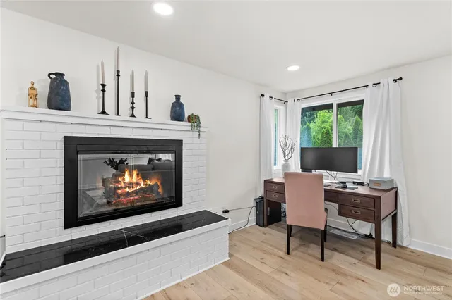 a living room with furniture a fireplace and a window
