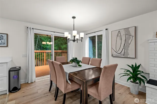 a dining room with furniture potted plants and wooden floor