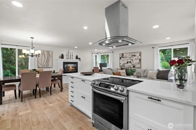 a kitchen with a stove cabinets and wooden floor