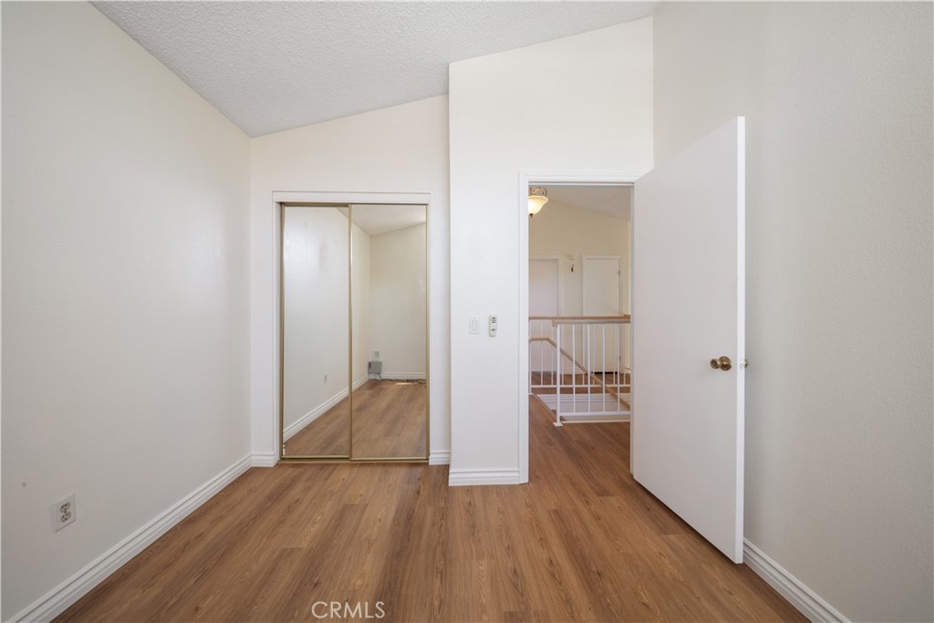 19422 Totem Court Riverside, CA 92508 - Photo 25 of 38 an empty room with wooden floor and a bathroom