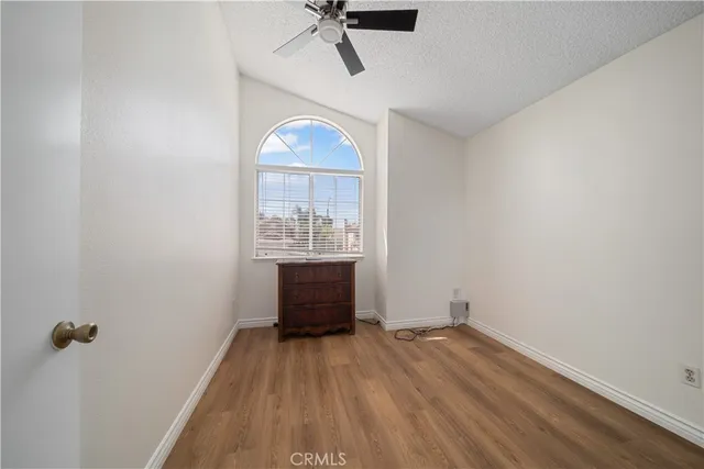 a view of empty room with a window and wooden floor