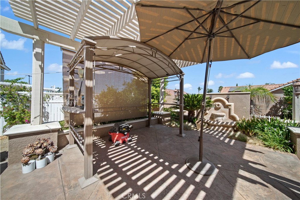 19422 Totem Court Riverside, CA 92508 - Photo 30 of 38 a view of a patio with table and chairs under an umbrella