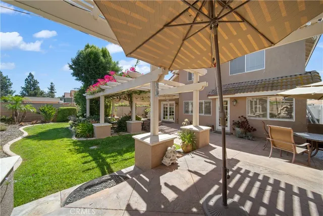 a view of a house with backyard sitting area and garden