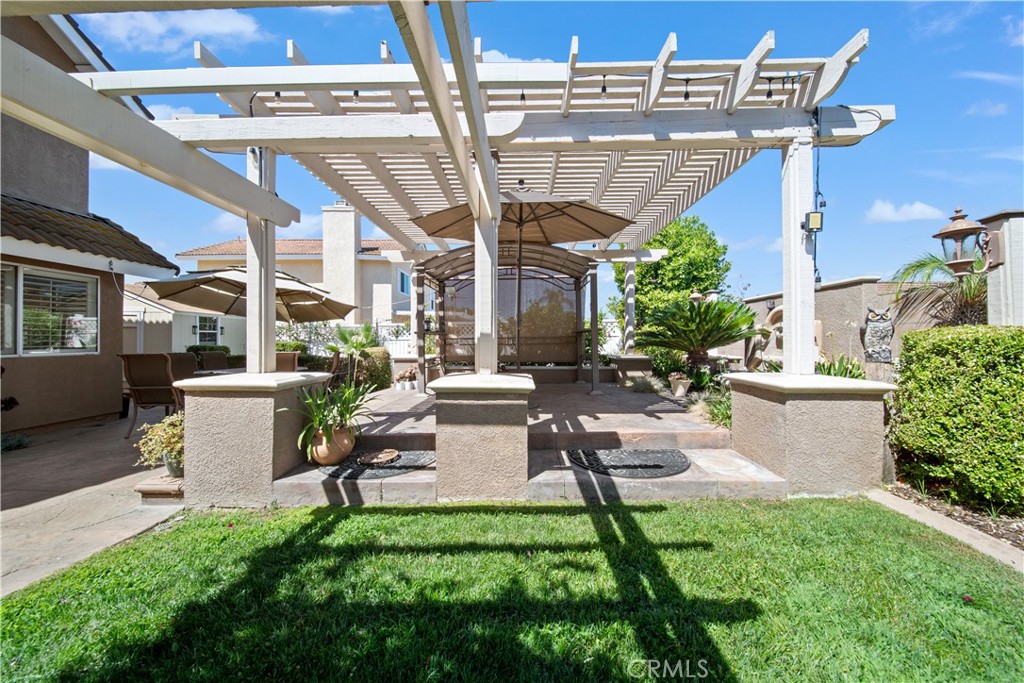 19422 Totem Court Riverside, CA 92508 - Photo 37 of 38 a view of a patio with couches table and chairs with potted plants