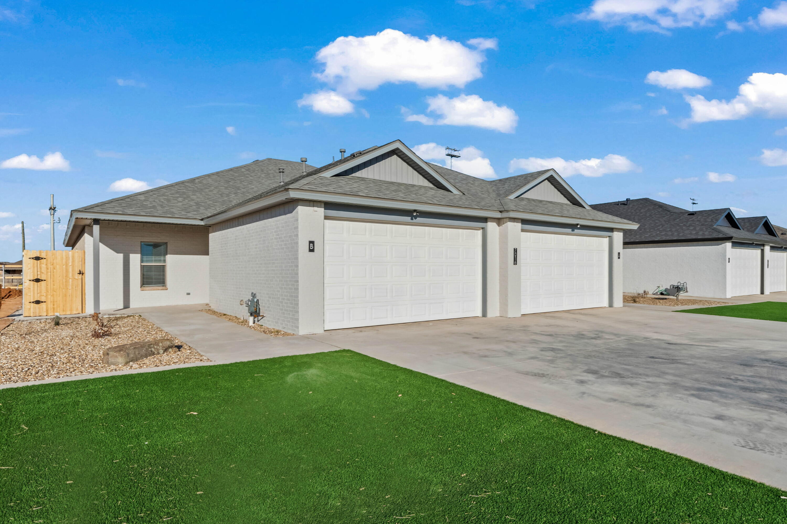 7016 40th Street Lubbock, TX 79407 - Photo 2 of 19 a front view of a house with a yard and garage