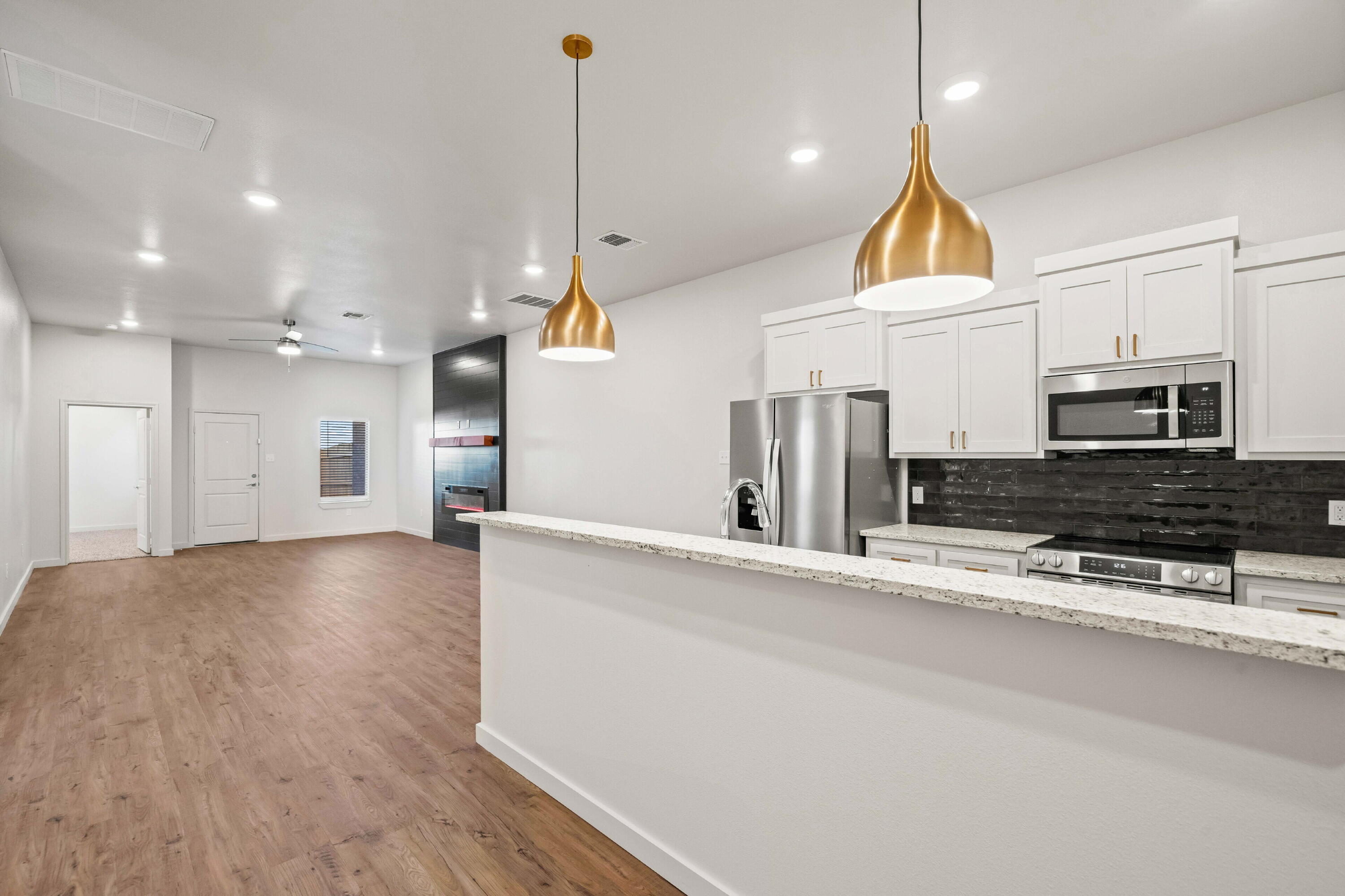 7016 40th Street Lubbock, TX 79407 - Photo 4 of 19 a view of a kitchen with a sink and a stove top oven
