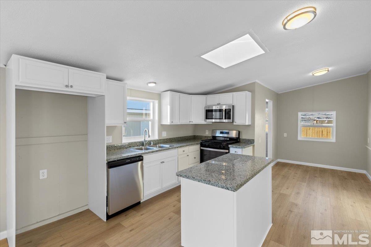 3545 Meadowlark Drive Reno, NV 89508 - Photo 4 of 15 a kitchen with a sink a counter top space and appliances