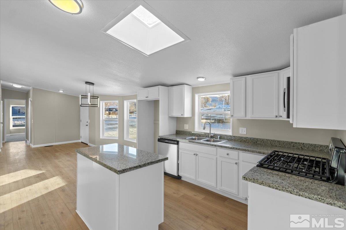 3545 Meadowlark Drive Reno, NV 89508 - Photo 5 of 15 a kitchen with stainless steel appliances granite countertop a stove and a sink