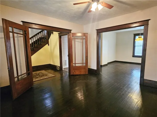 wooden floor in an empty room with a window
