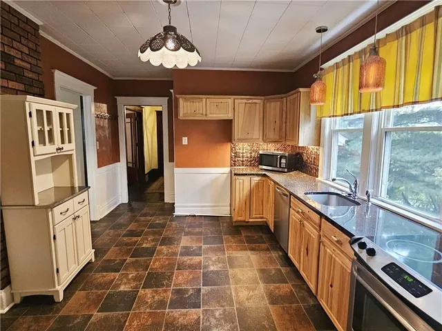 a kitchen with stainless steel appliances a sink stove and refrigerator