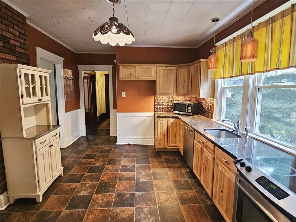 10361 Washington Avenue Irwin, PA 15642 - Photo 20 of 37 a kitchen with stainless steel appliances a sink stove and refrigerator