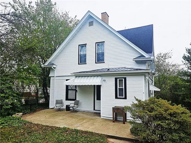 a view of a house with yard and sitting area