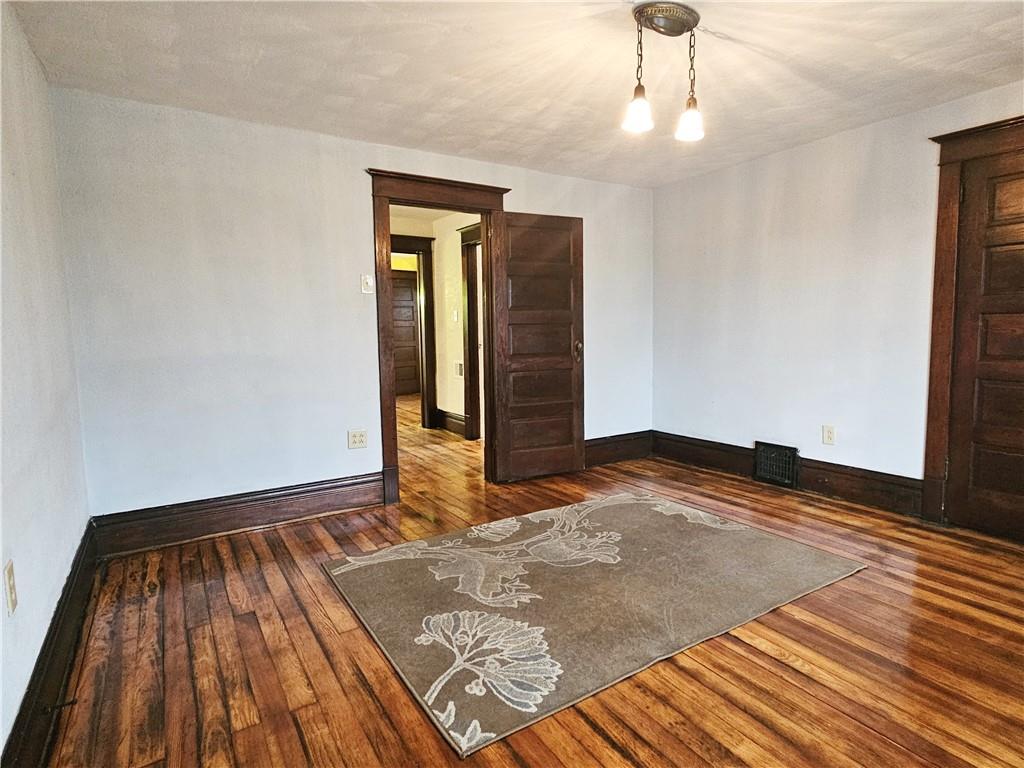 10361 Washington Avenue Irwin, PA 15642 - Photo 24 of 37 a view of a room with wooden floor and white walls