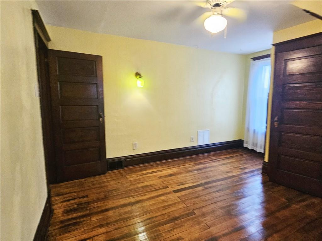 10361 Washington Avenue Irwin, PA 15642 - Photo 28 of 37 a view of an empty room with wooden floor and fan