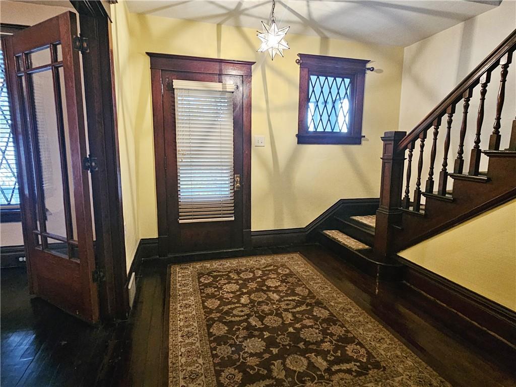 10361 Washington Avenue Irwin, PA 15642 - Photo 6 of 37 a view of a hallway with wooden floor and staircase