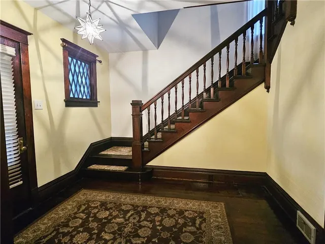 a view of entryway and hall with wooden floor
