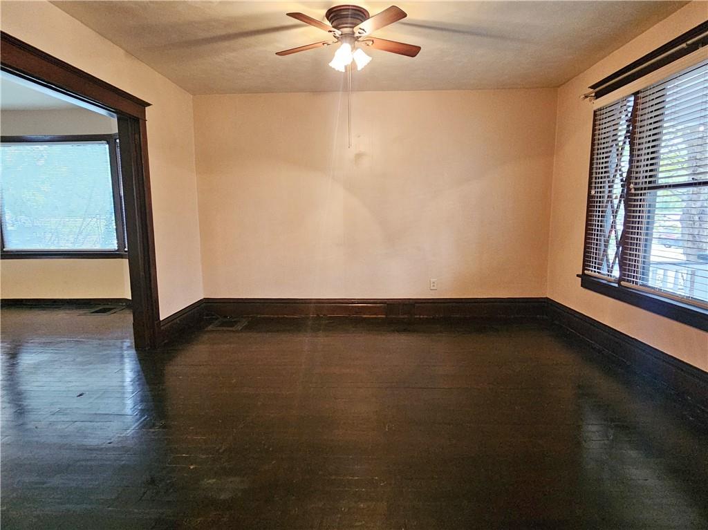 10361 Washington Avenue Irwin, PA 15642 - Photo 9 of 37 an empty room with wooden floor and windows