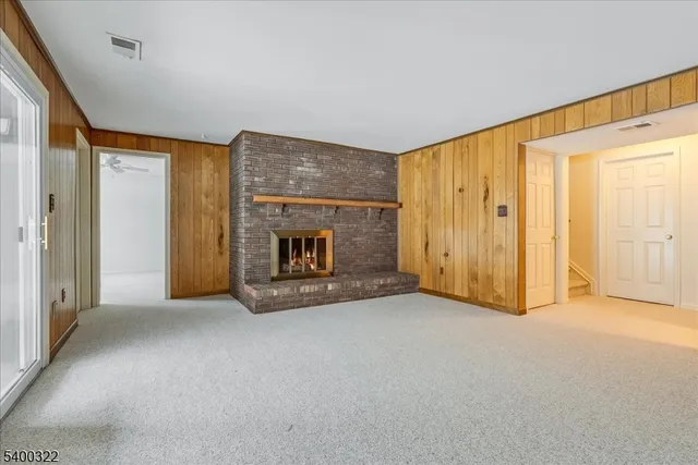 a view of an empty room with a fireplace