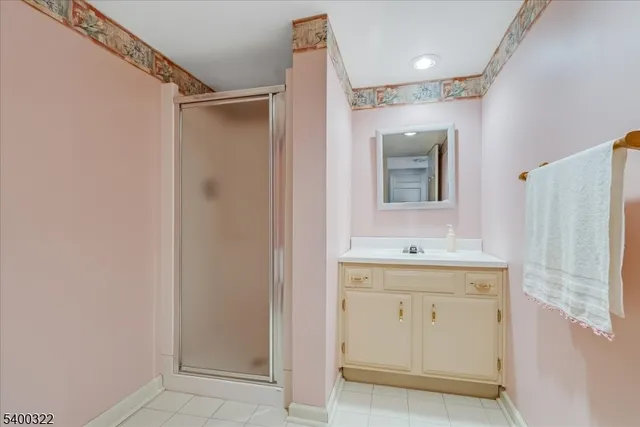 a bathroom with a shower sink and mirror