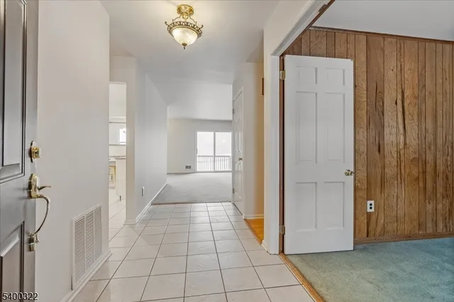 a view of a hallway to rooms