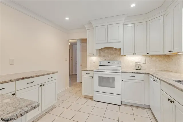 a kitchen with white cabinets stainless steel appliances and sink