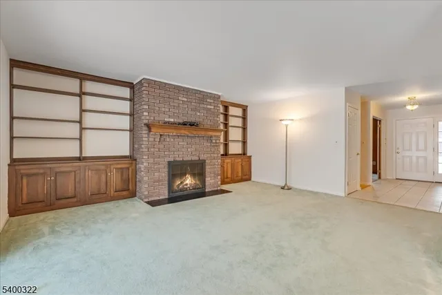 a view of an empty room with a fireplace