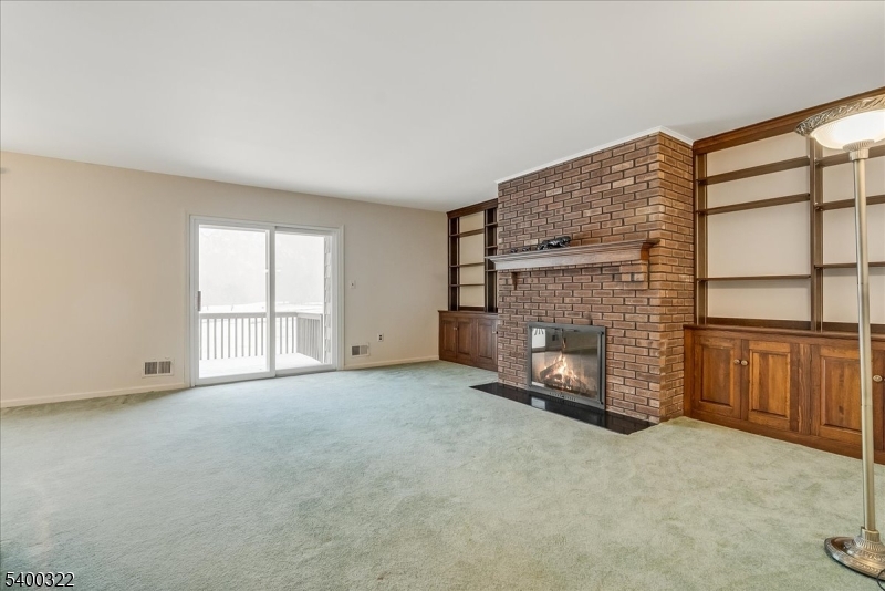 38 Goldfinch Drive Hackettstown, NJ 07840 - Photo 10 of 30 a view of an empty room with a fireplace and window