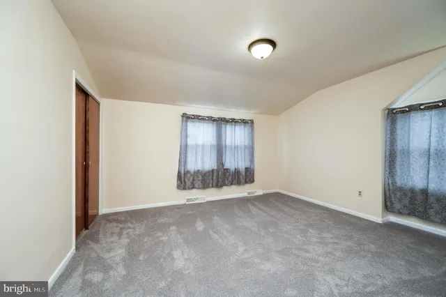 a view of an empty room with wooden walls
