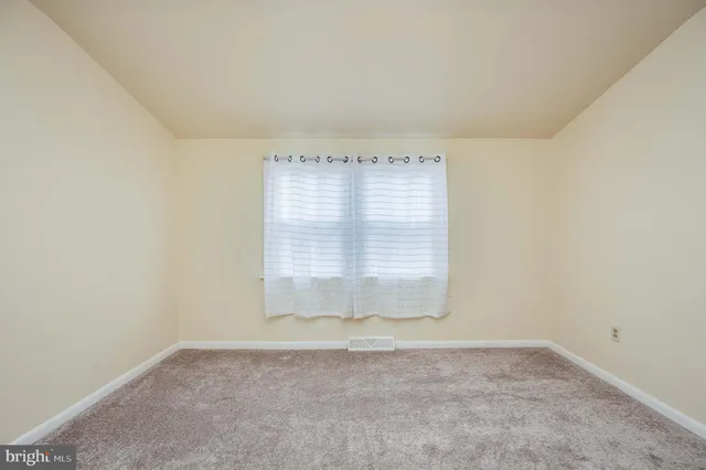 an empty room with a empty space and windows