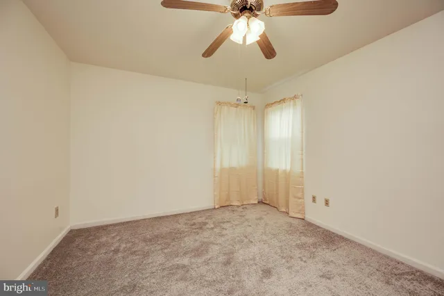 a view of a house with a big yard and large trees