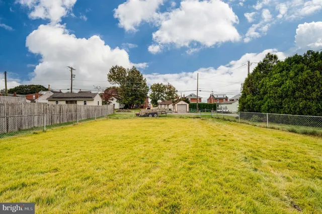a swimming pool with outdoor seating and yard